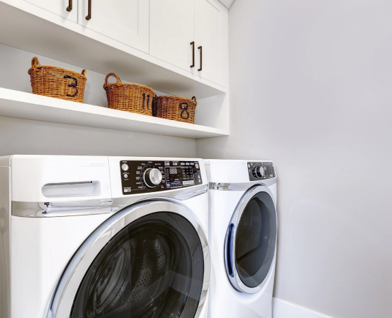 white appliance dryer and washing machine on a washing room