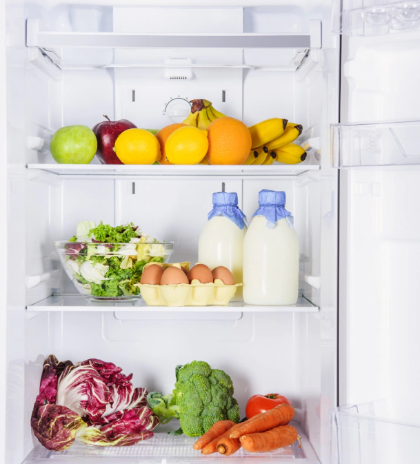 white refrigerator with some fruit and vegetables inside